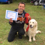 Andy with dog and certificate